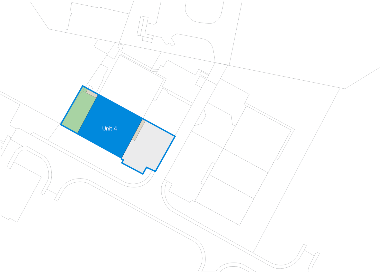 Site map showing several buildings with Unit 4 highlighted in blue and an adjacent green area on the left side of the unit. Surrounding roads and structures are outlined in grey.