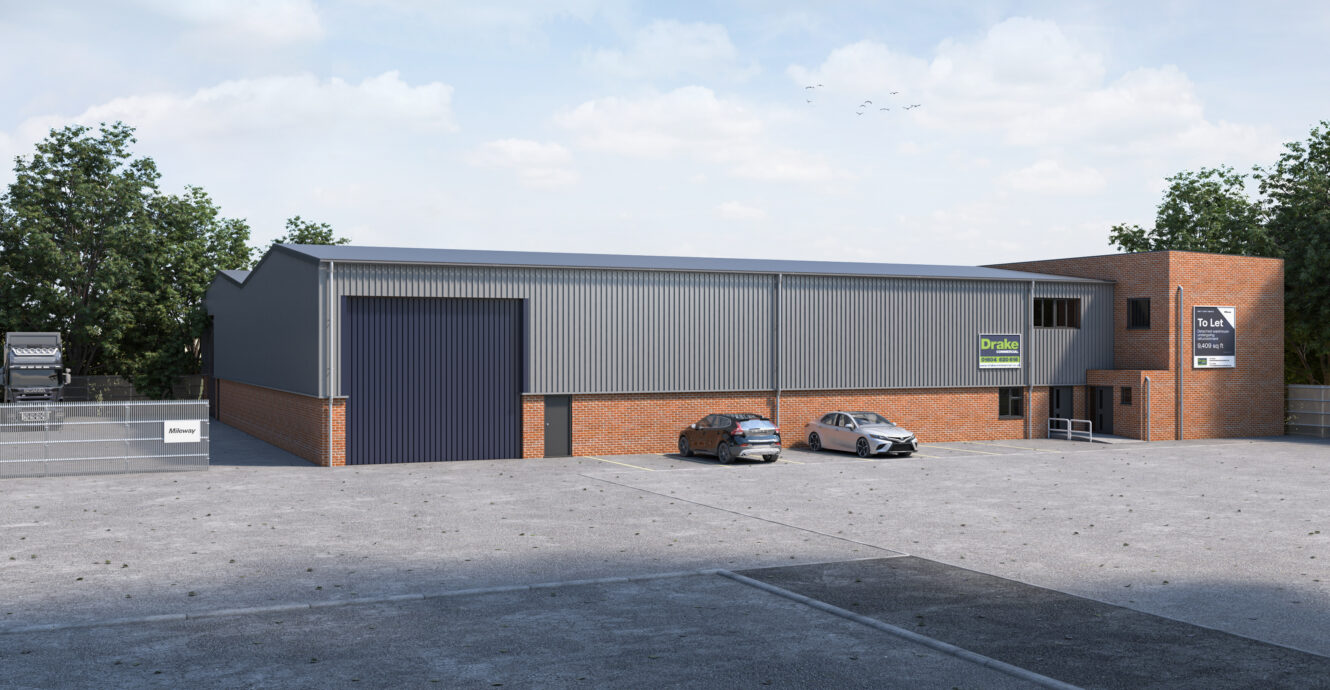 A large industrial warehouse with brick and metal exterior, two cars parked in front, and signage on the building under a partly cloudy sky.