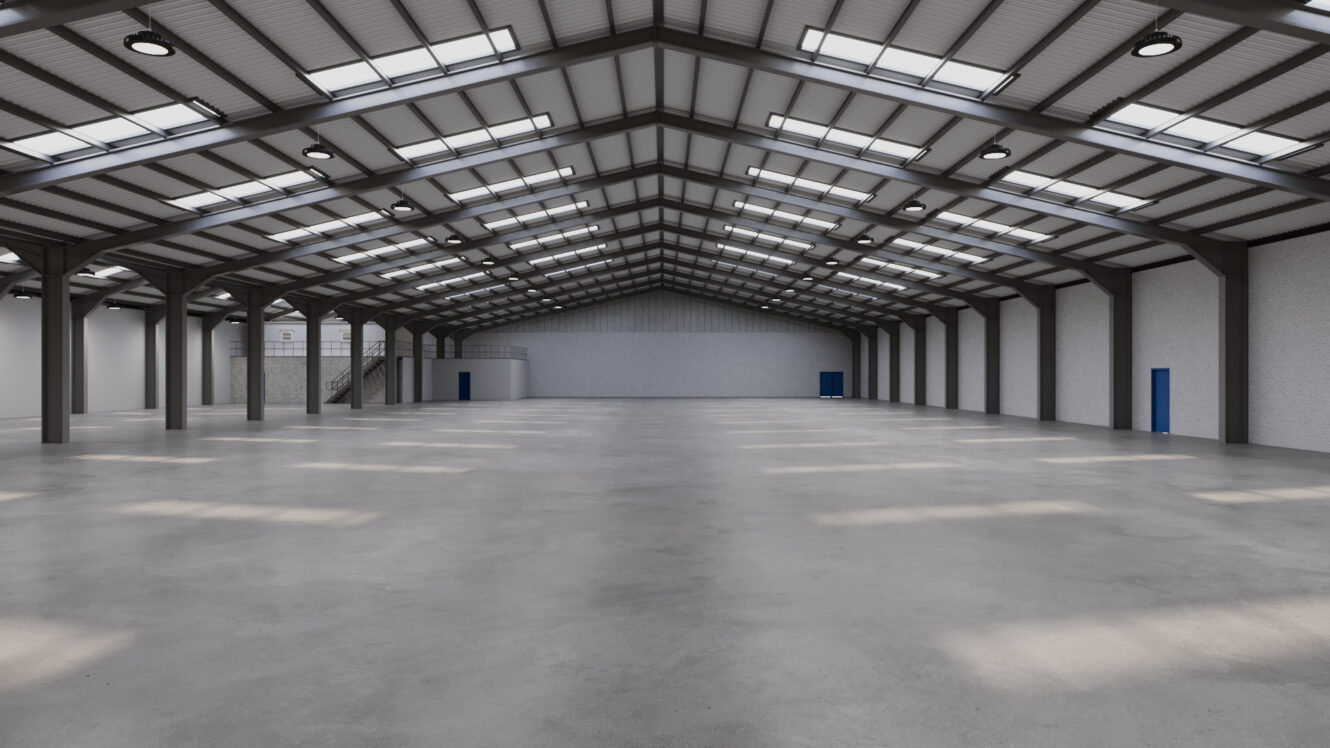 Interior of a large, empty warehouse with a concrete floor, metal beams, skylights on the roof, and blue doors set into white walls.