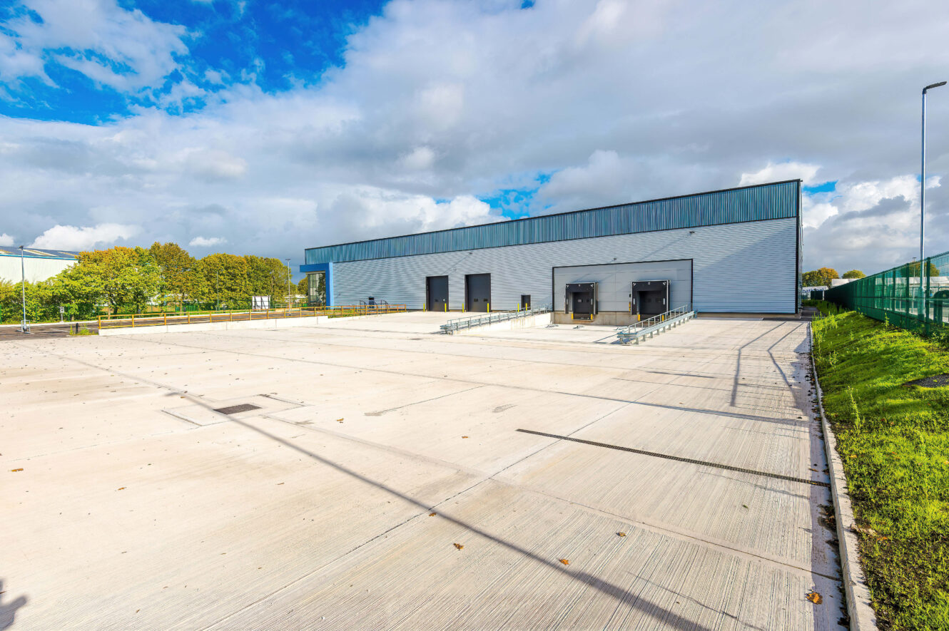 Warehouse building with two loading bays and a large concrete loading yard.