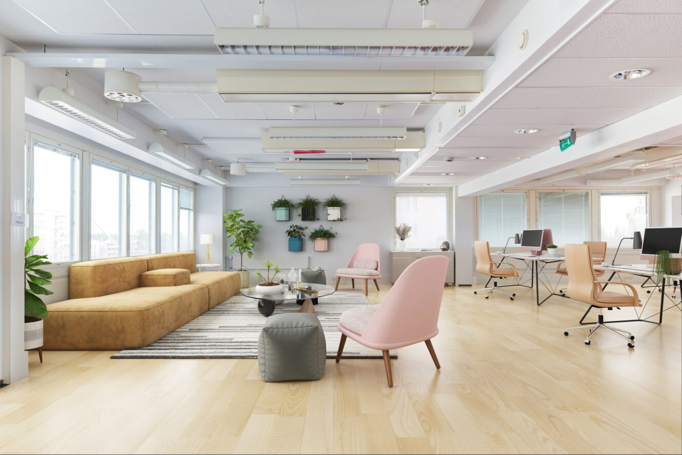 Moderni avotoimisto, jossa on työpöytiä, tietokoneita, oleskelutila, jossa on sohva ja tuoleja, suuret ikkunat, kasveja ja kirkas luonnonvalo.