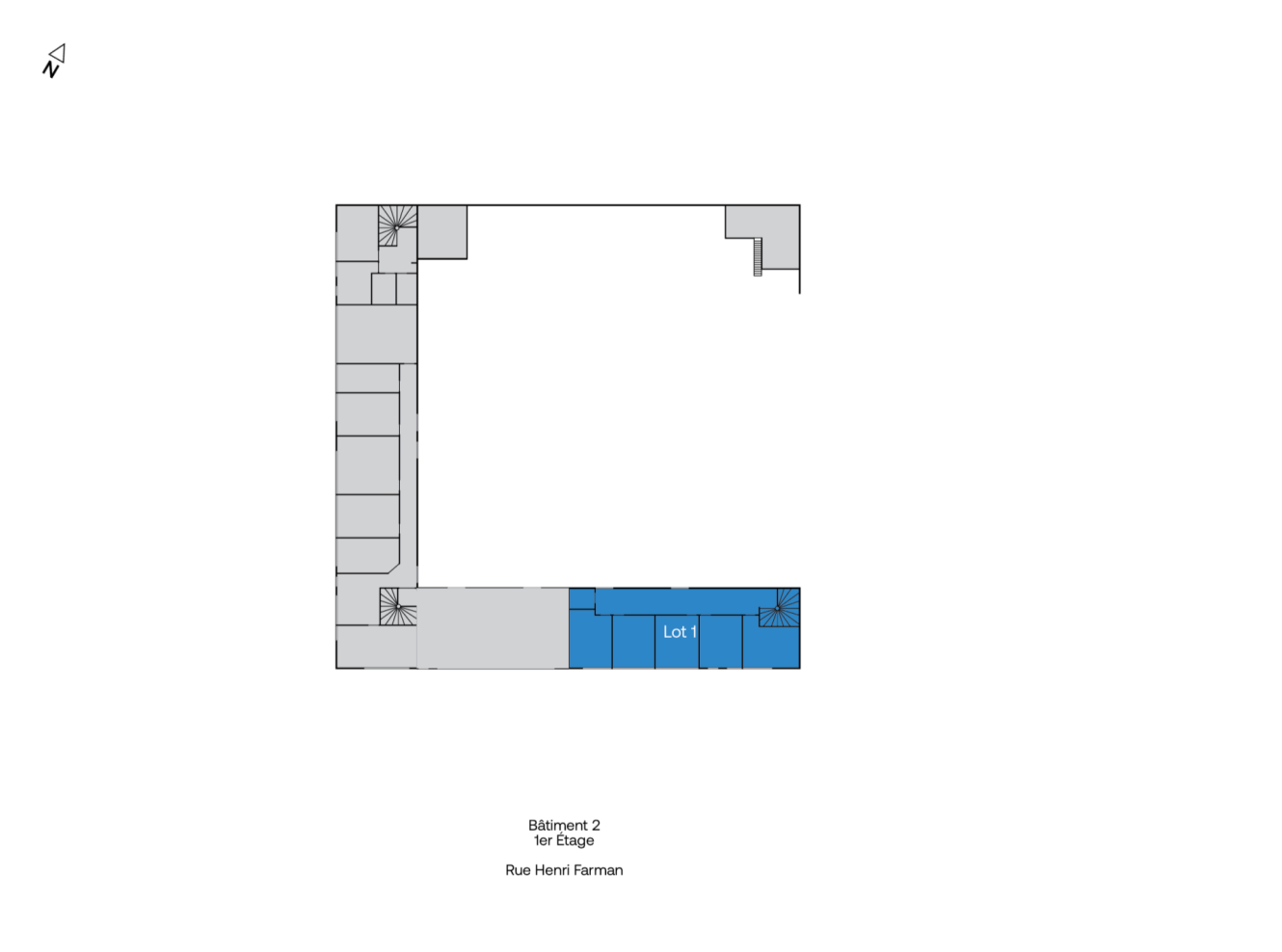 Plan d'étage en forme de L avec une section surlignée étiquetée Lot 1 en bas à droite ; le texte en dessous indique Bâtiment 2, 1er Étage, Rue Henri Farman.