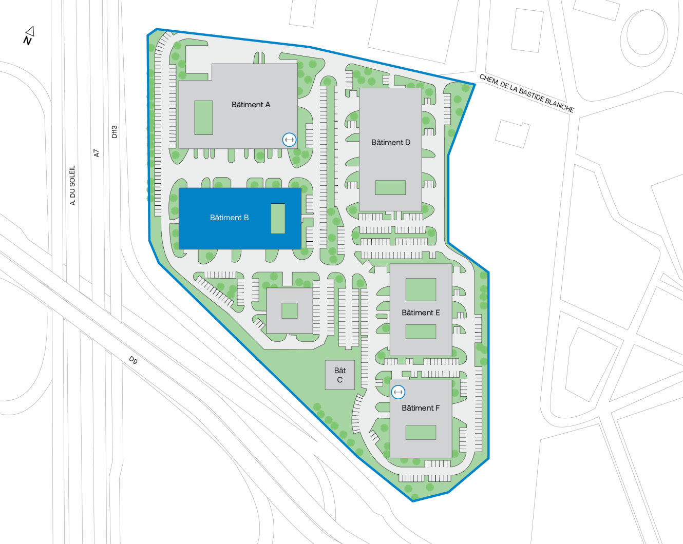 Plan du site présentant six bâtiments identifiés par des lettres (A à F), des parkings, des routes et des espaces verts à l'intérieur d'un périmètre délimité ; la flèche indiquant le nord et les routes avoisinantes sont indiquées.