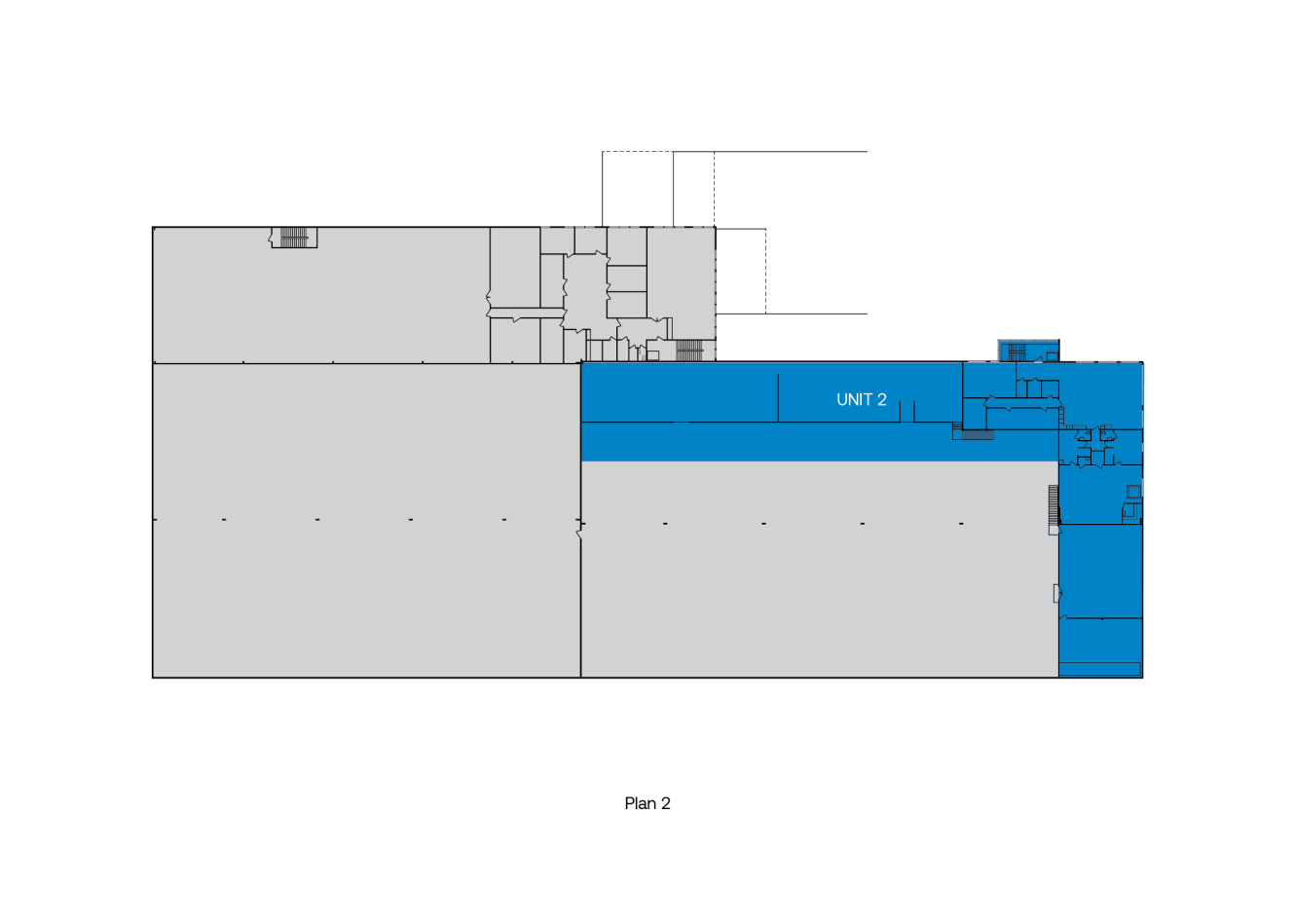 Planritning med en sektion märkt UNIT 2 markerad med blått, som visar olika områden inom en byggnadslayout.