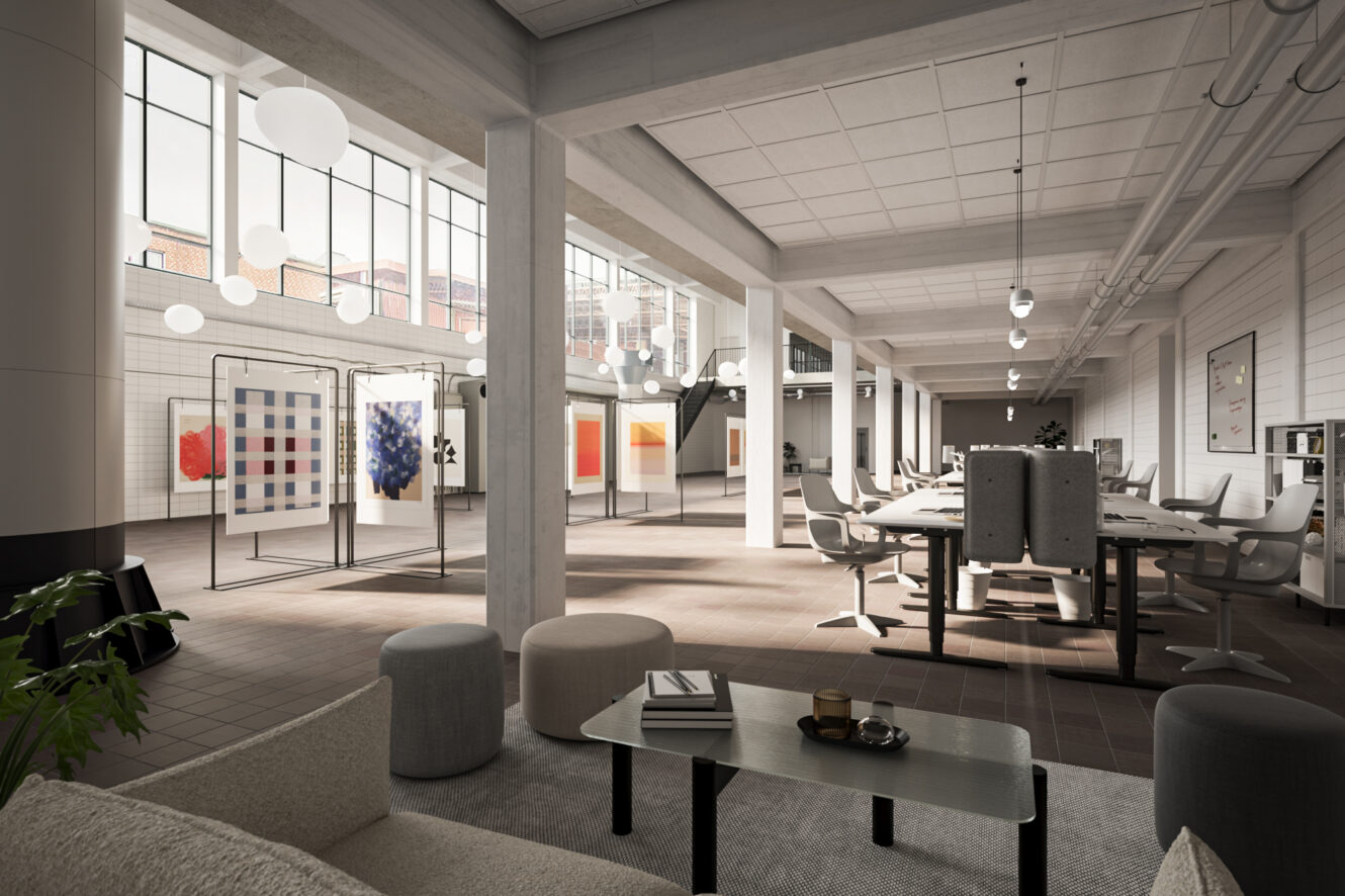 Rymligt, modernt kontor med öppna arbetsstationer, loungemöbler, stora fönster och abstrakt konst på skiljeväggarna.