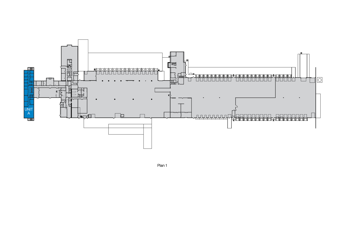 Planlösning med märkta sektioner; vänster sida visar ett blåmarkerat område märkt UNIT A, med flera rum och öppna ytor i hela byggnaden.